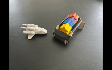 Spaceship experiments: one is 3D printed, the other is done with cardboard (players prefer the handmade version because all the meeple can fit inside!)